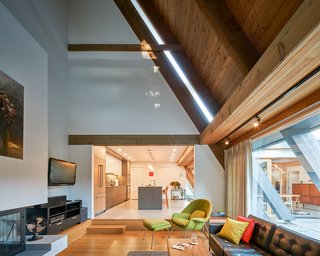 The soaring vaulted ceiling and the spirit of the living room were preserved, and the entire lower level was enhanced by opening up the space, creating a smooth flow from the living room into the kitchen and dining areas. 