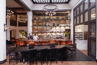 Studio Collective outfitted the double-height, soaring lobby space in the spirit of great European hotel bars. 