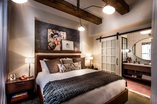 Exposed wood beams are set against contemporary artwork and custom furniture. Painted cement tiles adorn one of the hotel's suites.
