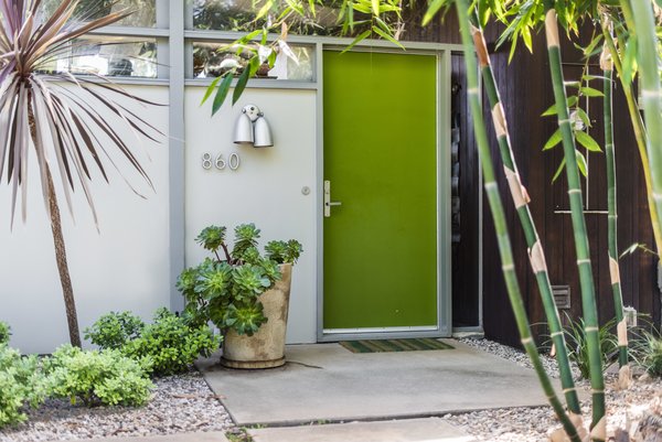 A bright green door pairs well with the surrounding foliage.