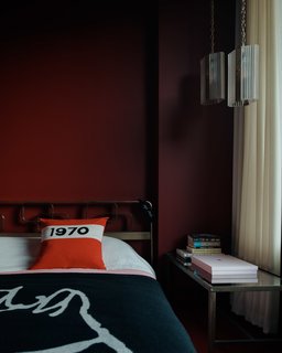 The bedspreads and decorative pillows duplicate the text and illustrations found on Freud’s famous knitwear.