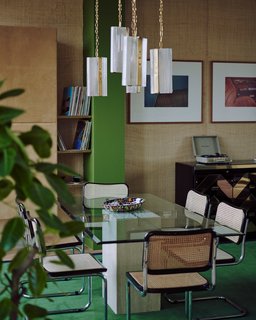 The open-plan living/dining room features an elegant mix of textures and materials. 