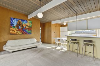 The floor plan has not been altered over the years. The kitchen overlooks a sitting room and the atrium beyond. 