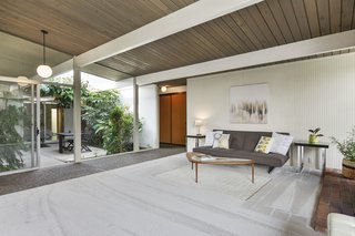 Walls of glass fill the home with natural light. 