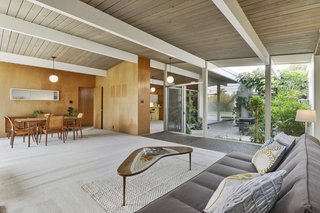 The tongue-and-groove ceiling has not been painted, and globe pendant lighting abounds.