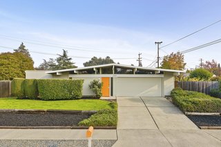 3767 Barrington Drive features a classic Eichler profile and an inviting bright orange front door. 
