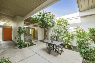 The spacious open-air atrium has a bit of a jungle-like feel, and it brings a strong sense of the outdoors into the home. 