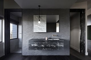 The minimalist bathroom provides a calm, introspective experience.