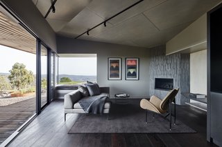 The open-plan living space provides a front-row seat to the spectacular scenery, which is framed by floor-to-ceiling sliding doors that further integrate the outdoors.