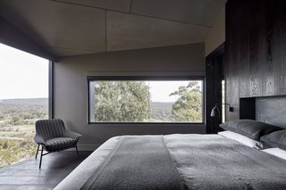 The bedroom also boasts a wall of sliding glass doors that open the home to its surroundings. 