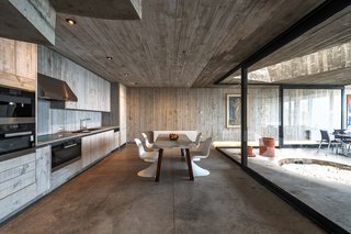 The main level holds the living room, dining room, kitchen, and an interior courtyard with a fire pit.
