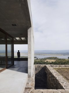 A stone staircase leads to the lower level. 
