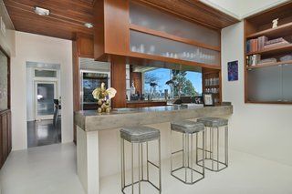 The wood-and-stone bar at the edge of the living room makes for easy entertaining. 
