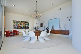 The spacious, formal dining room features a floating credenza. 