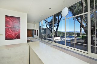 Sixteen-foot ceilings and glass doors seamlessly connect the living spaces to the outdoors. <font color="#cccccc"><span style="font-size: 13px;">Courtesy of The Agency</span></font>