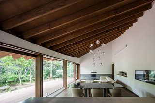 The ceiling features exposed wood beams which extend straight out to the eaves. 