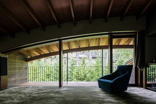 The arched form of the roofline provides a cozy, second-floor interior space. 