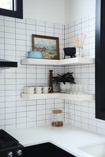 A Petite Cast Iron Fondue Set from Schoolhouse sits on a kitchen shelf. 