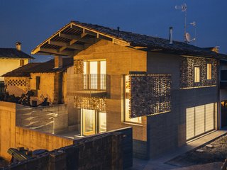 The home lights up from within at night. 