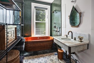 The master bath features a wooden bathtub imported from Scotland.