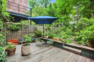 Just off the kitchen, a magical 55-foot-deep garden features an outdoor bathtub and shower—perfect for indoor/outdoor living. 