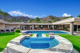 The pool is the centerpiece of the home's expansive outdoor space.