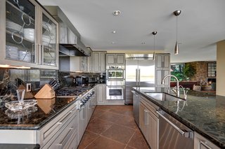 The updated kitchen comes with a breakfast bar, granite countertops, and stainless steel appliances.