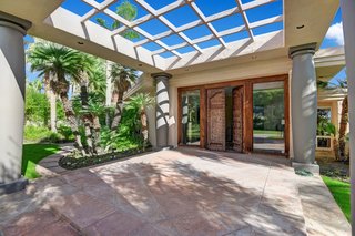 The entrance to the home features hand-carved Moroccan wooden doors.