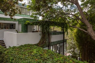 The residence is perfectly integrated into the adjacent hillside. 