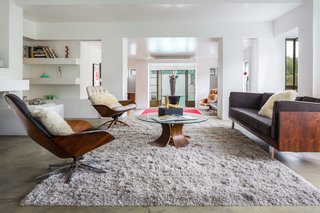 The lower level has a long, open living space which extends from the dining area out towards the pool. Here is a view from the living room towards the pool.