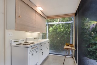 The cozy kitchen maintains a connection to the outdoors. 