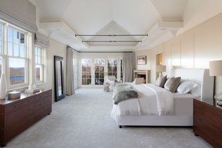 The master suite includes a gas fireplace, a balcony, and an enormous walk-in closet