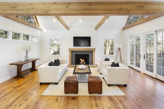 The luminous living room of the "George Washington House" features a soaring, beamed ceiling and extensive glazing. 