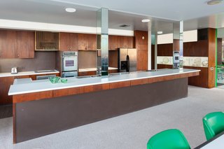 The open kitchen overlooks the dining area. 
