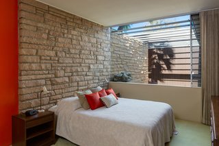 The third bedroom features a groovy stone inlay wall, which carries into the home from the exterior.