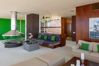 The living area features a hanging stainless steel hearth. 