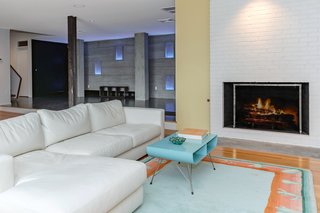 In addition to a wet bar and laundry room, the downstairs has a large, open space—once known as the children's living room—with a wood-burning fireplace and direct access to the grounds and pool.