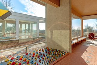 The home's flooring ranges from paved brick to reclaimed teak. The ceilings are made from textured Portuguese cork, which seamlessly transitions out to the soffits. 