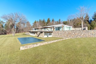 A long bluestone roof deck overlooks the pool and the expansive lawn.