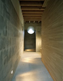 The sauna area is constructed from natural materials like stone and wood. 