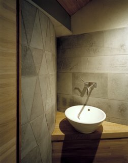 Geometric stonework accents the area around the sink.