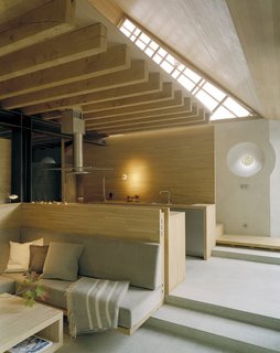 The open-plan living space is clad in solid oak and features natural Öland limestone surfaces.