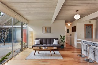 The kitchen overlooks a sitting area and enjoys atrium views. 