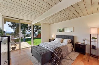 The master bedroom has sliding glass doors which lead to the backyard. 
