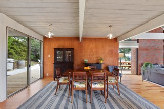 The dining room as it connects to the living room. The space is flooded with natural light. The floors have been recently updated to engineered hickory. 