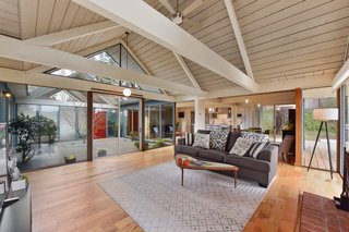 The open-plan living area features soaring, vaulted ceilings thanks to the double A-frame design. 