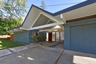 The home features a one-car garage and a covered carport. 