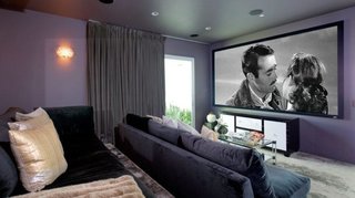 The home theater features tiered, cozy sofa seating. 
