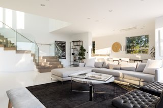 The open-plan living space is bright, white, and airy. 