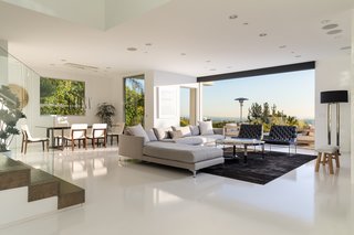 The living room fully opens and extends to the terrace, allowing for indoor/outdoor living. 